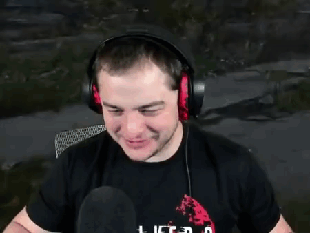 A Man Wearing Headphones And A Black Shirt Is Talking Into A Microphone . GIF