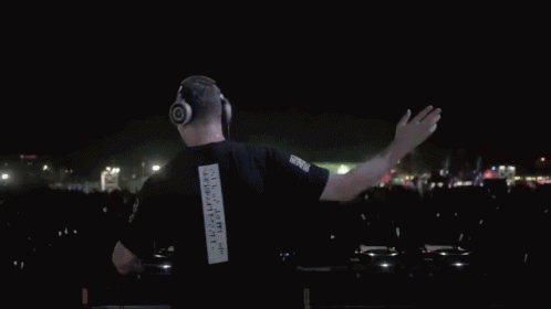 A Man Wearing Headphones And A Black Shirt With The Number 1 On The Back GIF