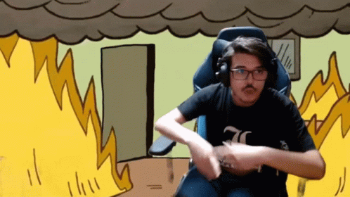 A Man Wearing Headphones And A Black Shirt With The Number 70 On It Is Sitting In Front Of A Fire GIF