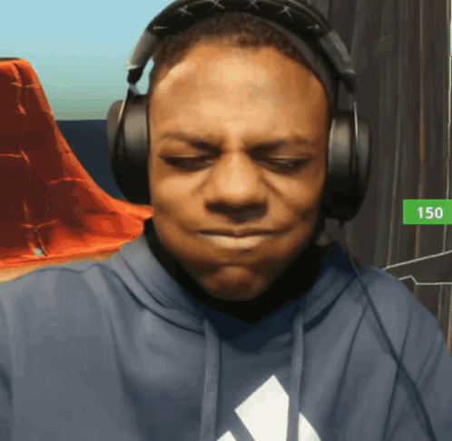 a man wearing headphones and a blue adidas hoodie