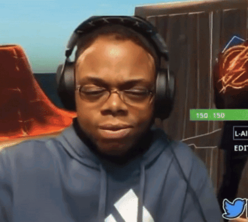 A Man Wearing Headphones And A Blue Adidas Shirt Is Looking Down GIF