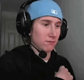 a man wearing headphones and a blue hat with a microphone on his head .