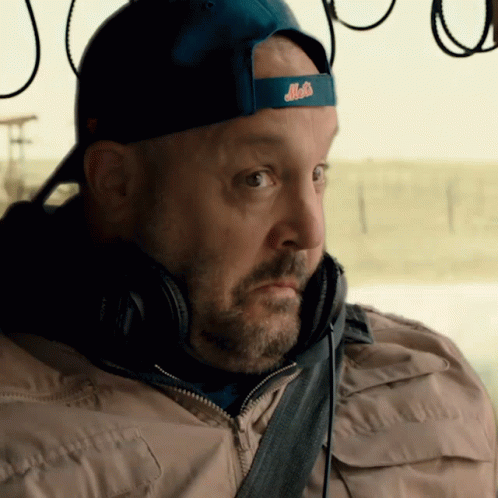 A Man Wearing Headphones And A Blue Hat With The Word Mets On It GIF