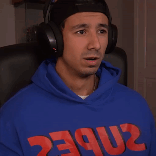 A Man Wearing Headphones And A Blue Hoodie That Says 2Nbec On It GIF