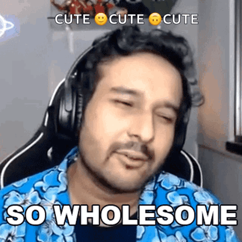 A Man Wearing Headphones And A Blue Shirt Is Saying So Wholesome GIF