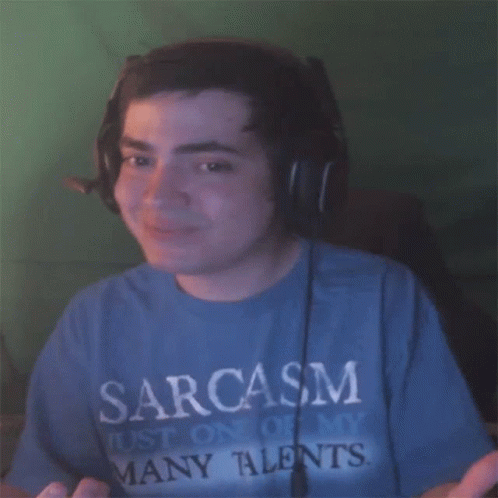 A Man Wearing Headphones And A Blue Shirt That Says Sarcasm On It GIF