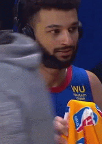 A Man Wearing Headphones And A Blue Shirt With Wu Western Union On It GIF