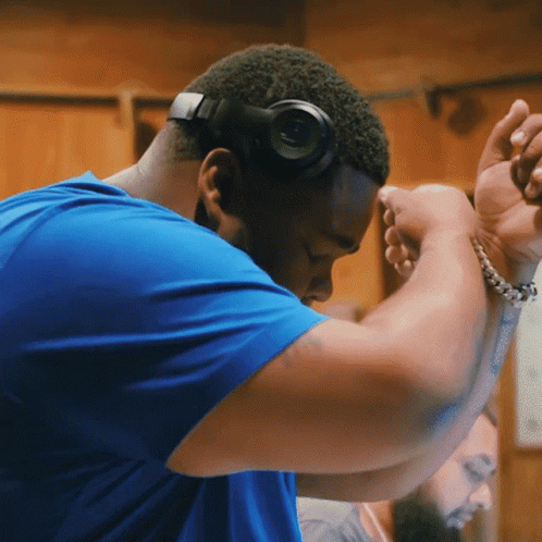 A Man Wearing Headphones And A Blue Shirt GIF
