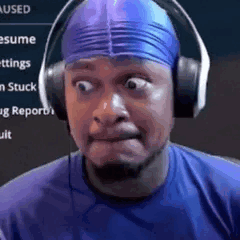 A Man Wearing Headphones And A Blue Swim Cap Is Making A Face . GIF