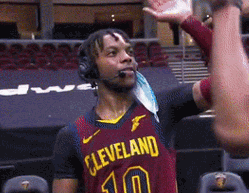 A Man Wearing Headphones And A Cleveland Jersey With The Number 10 On It GIF