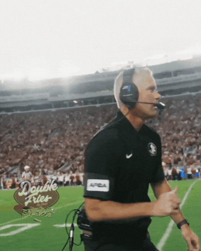 a man wearing headphones and a double fries sign on the field