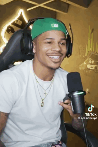 Smiling Man With Headphones And Green Hat GIF