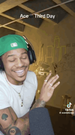 Man With Headphones Smiling In Front Of Microphone GIF