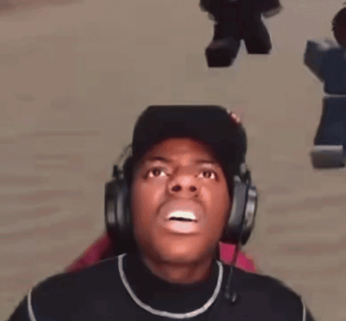 a man wearing headphones and a hat is making a face .