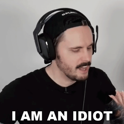 A Man Wearing Headphones And A Hat Is Saying " I Am An Idiot " GIF