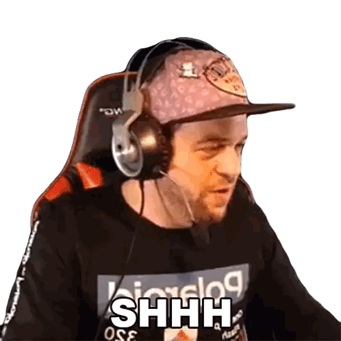 a man wearing headphones and a hat is sitting in a chair .