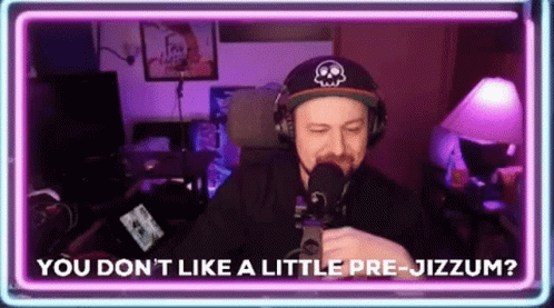 A Man Wearing Headphones And A Hat Is Talking Into A Microphone While Sitting In Front Of A Neon Sign . GIF