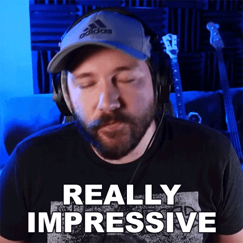 A Man Wearing Headphones And A Hat Says " Really Impressive " GIF