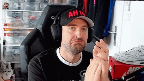 a man wearing headphones and a hat that says ah10 on it