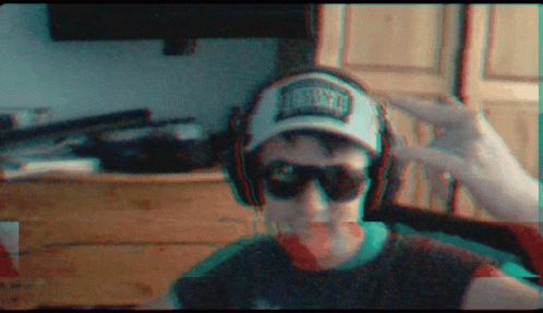 A Man Wearing Headphones And A Hat That Says Miami GIF