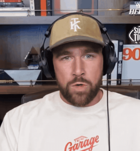 a man wearing headphones and a hat that says tk
