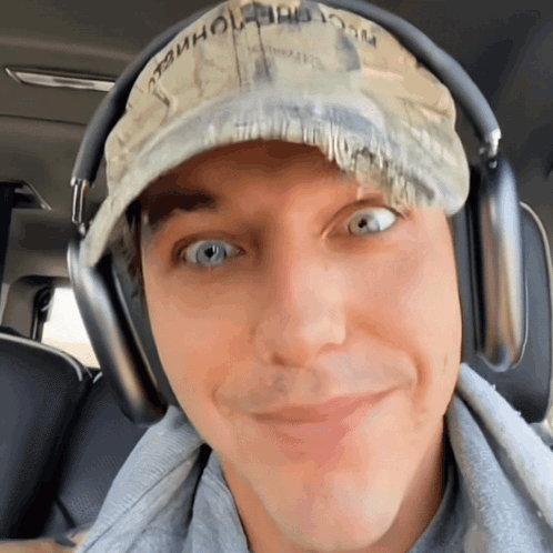 a man wearing headphones and a hat that says " washington " on it