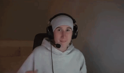a man wearing headphones and a headband is reaching out with his hand