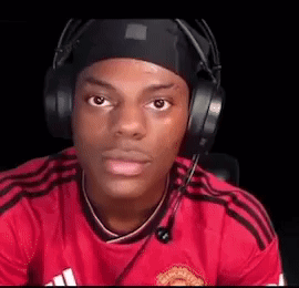 A Man Wearing Headphones And A Headband Is Sitting In Front Of A Computer Screen . GIF