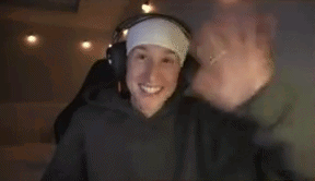 a man wearing headphones and a headband is waving his hand .