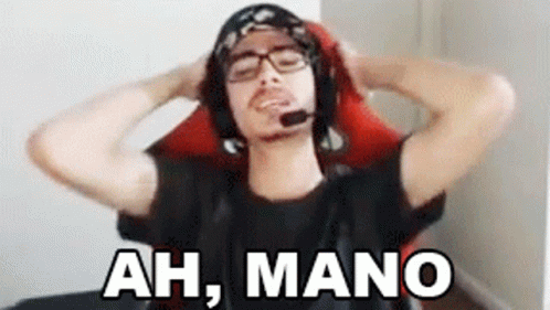 a man wearing headphones and a headset is sitting in a chair with his hands behind his head and says ah mano .