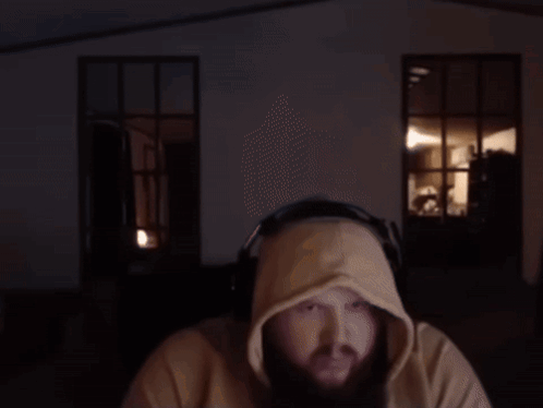 A Man Wearing Headphones And A Hooded Sweatshirt GIF