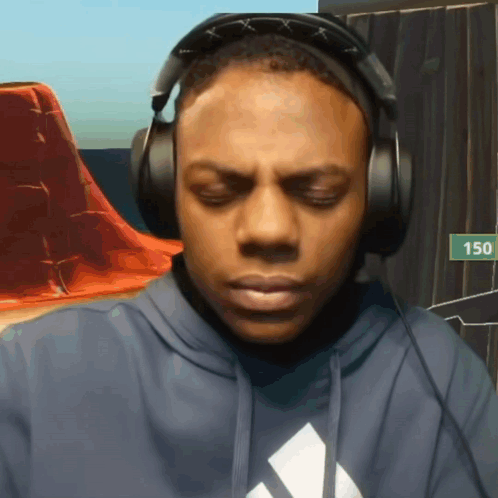 A Man Wearing Headphones And A Hoodie With The Number 150 In The Background GIF