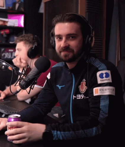A Man Wearing Headphones And A Jacket That Has Toyota On It GIF