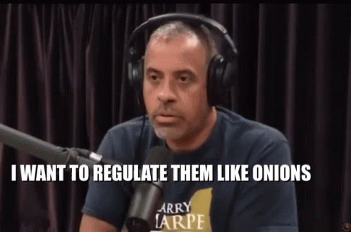 A Man Wearing Headphones And A Larry Tarpe Shirt Is Talking Into A Microphone GIF