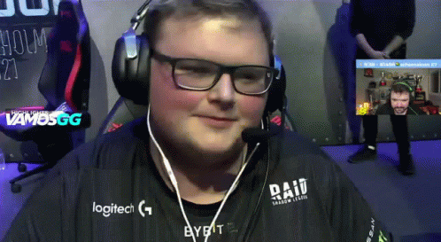 A Man Wearing Headphones And A Logitech Shirt Is Smiling GIF