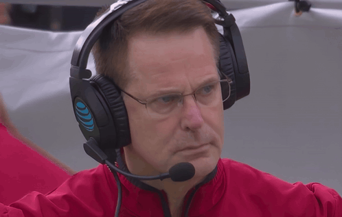 A Man Wearing Headphones And A Microphone Has A Blue Circle On The Left Ear GIF