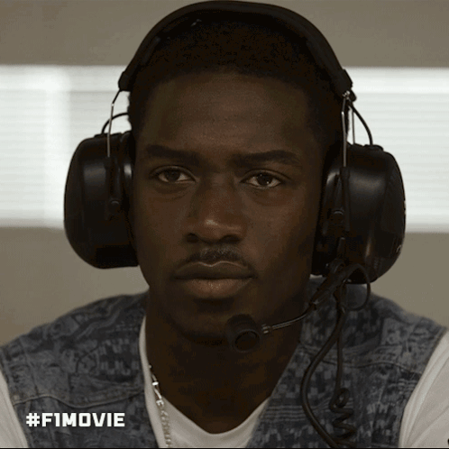 A Man Wearing Headphones And A Microphone Has #Fimovie Written On The Bottom Right GIF