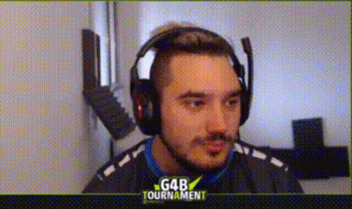 A Man Wearing Headphones And A Microphone Is Looking At The Camera . GIF