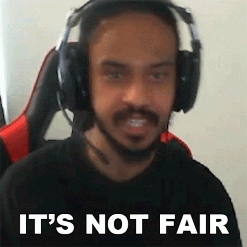 a man wearing headphones and a microphone is making a funny face and saying it 's not fair .