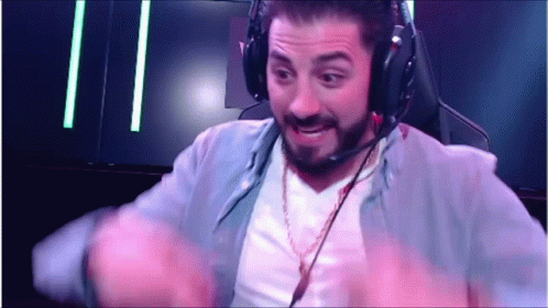 A Man Wearing Headphones And A Microphone Is Sitting In A Chair . GIF