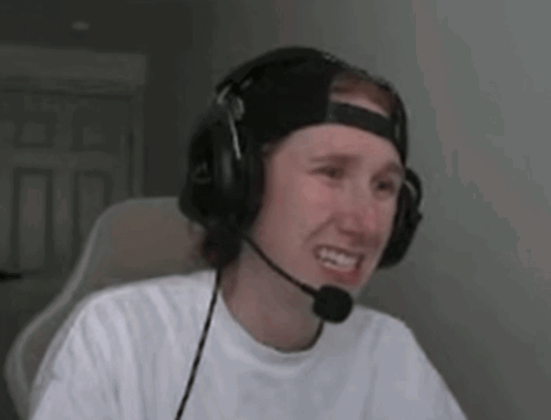 a man wearing headphones and a microphone is sitting in a chair .