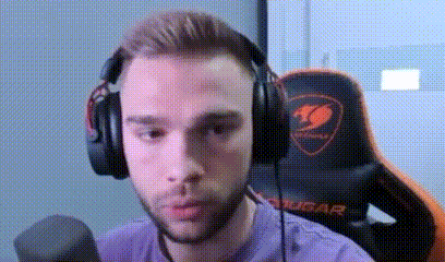 A Man Wearing Headphones And A Microphone Is Sitting In A Gaming Chair . GIF