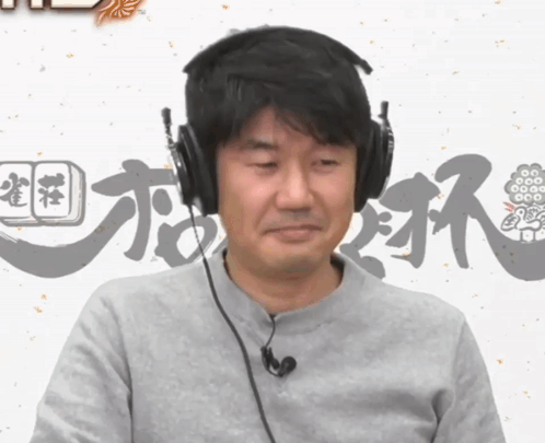 A Man Wearing Headphones And A Microphone Looks At The Camera GIF