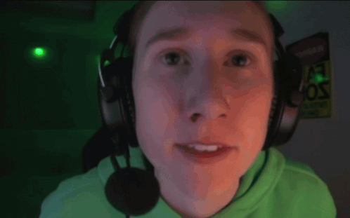 a man wearing headphones and a microphone smiles