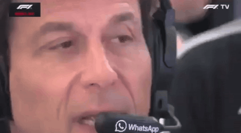 A Man Wearing Headphones And A Microphone With The Word Whatsapp On It GIF