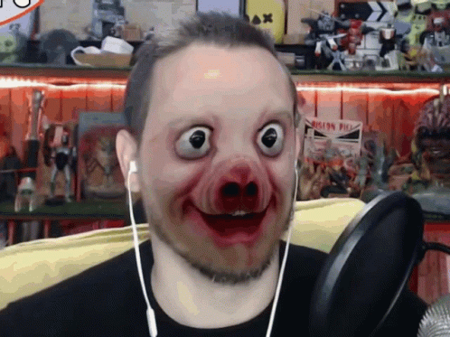 A Man Wearing Headphones And A Pig Mask Looks At The Camera With A Sign In The Background That Says Iron Pier GIF