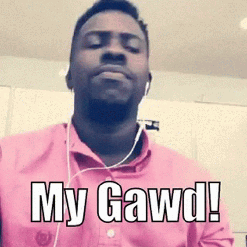 A Man Wearing Headphones And A Pink Shirt With The Words `` My Gawd '' Written On It . GIF
