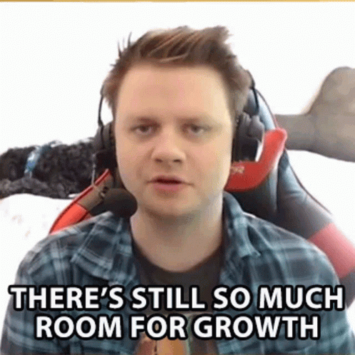 A Man Wearing Headphones And A Plaid Shirt Is Sitting In A Chair And Talking . GIF
