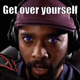 A Man Wearing Headphones And A Purple Hat Has The Words Get Over Yourself Written On His Face GIF