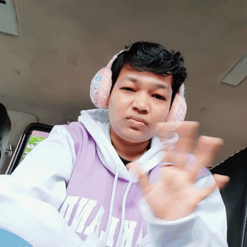 A Man Wearing Headphones And A Purple Hoodie That Says Kilian On It GIF